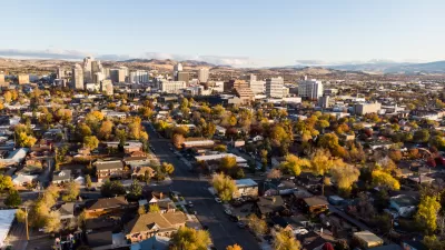 Aerial view of Reno, Nevada with homes in foreground and downtown buildings in background during autumn.