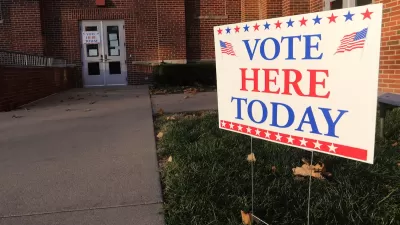 "Vote Here Today" yard sign in front of brick building.
