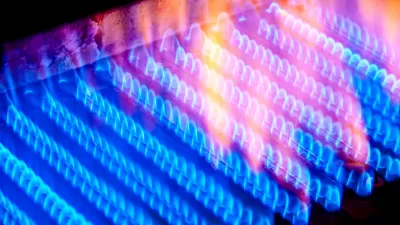 Close-up of multiple lines of blue natural gas flames inside a boiler.