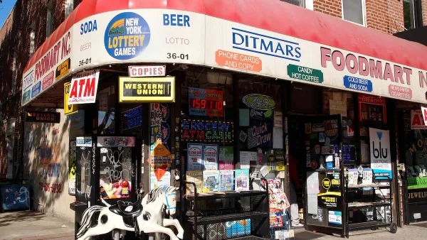 Corner convenience store with red awning and children's rocking horse toy out front in brick building in Queens, New York City