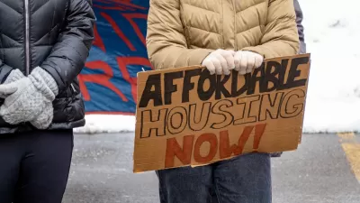 Close-up on protester holding Affordable Housing Now sign.