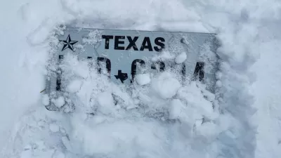 Texas license plate almost entirely covered by snow
