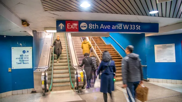 People walking up and down stairs in New York City subway station.