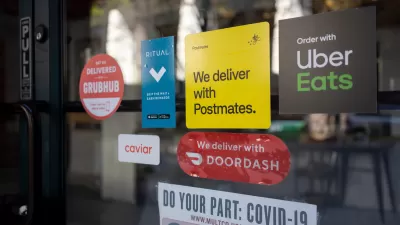 Close-up of restaurant window with various food delivery company stickers