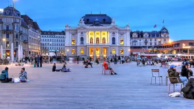 People in large plaza in front of Zurich Opera House in Switzerland.