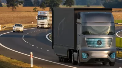 Self-driving Mercedes semi truck on highway with white semi truck behind it