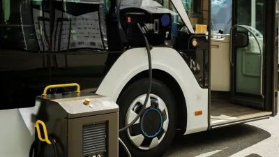 Close-up of electric bus being charged with portable charger.