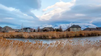 Homes in Saratoga Springs, Utah with pond in foreground.