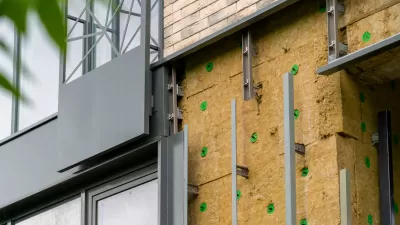 Installation of external wall thermal insulation with rock wool on Passive House residential building.