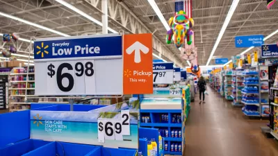 Interior of Walmart store with "Low Price $6.98" sign in foreground