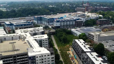 Aerial view of Atlanta BeltLine trail with colorful outdoor patio umbrellas and buildings.
