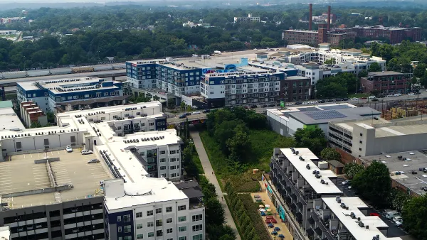 Aerial view of Atlanta BeltLine trail with colorful outdoor patio umbrellas and buildings.