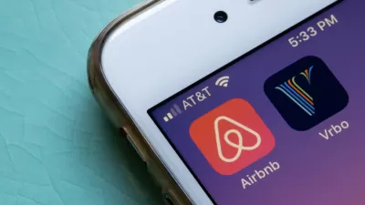Close-up of mobile phone with Airbnb and VRBO app icons.