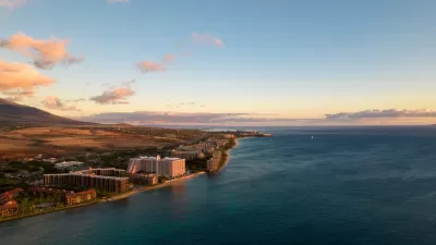 Aerial view of coast in Maui, hawaii with hotels and condo buildings at sunrise or sunset.