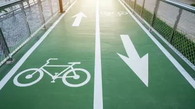 Green painted two-way bike lane with bike symbols and arrows.