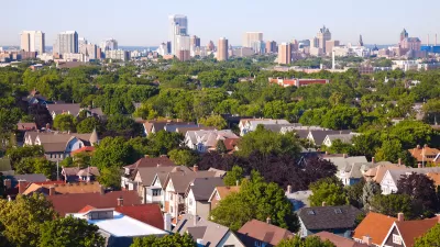 Milwaukee, Wisconsin skyline with houses in foreground.