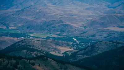 Aerial view of small rural community nestled in sprawling green valley in Washington State