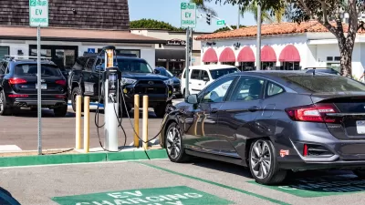 Car parked at EV charging station in parking lot in Carlsbad, California.