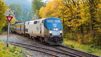 An eastbound Amtrak Empire Builder passes through the Cascade Mountains as the trees turn fall colors in Skykomish, WA
