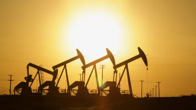 Four oil wells sillhouetted against the sunset.