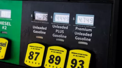 Close-up of gas pump with yellow buttons and price screens.