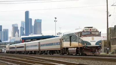 Amtrak train with downtown Seattle in background.