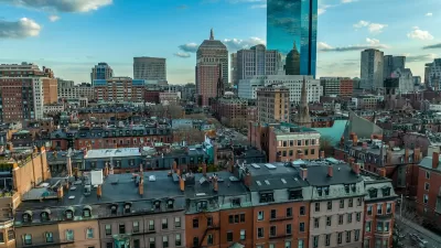 Aerial view of downtown Boston, Massachusetts with older buildings in foreground and modern glass towers in background.
