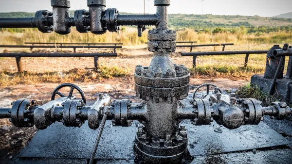 Close-up of dirty pipe at oil drilling operation.