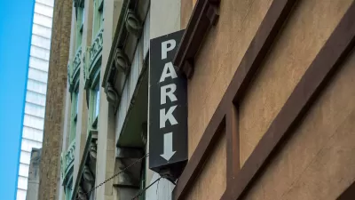 Close-up of vertical PARK sign on multistory urban parking garage.