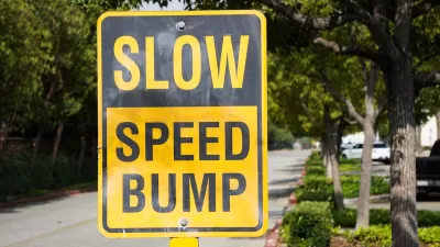 Yellow and black "SLOW SPEED HUMP" sign on residential street
