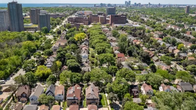 Aerial view of homes in Milwaukee, Wisconsin with brick university buildings in distance.