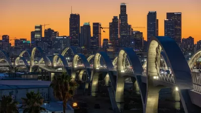 Downtown Los Angeles skyline at sunset with new 6th Street Viaduct arches in foreground.