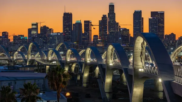Downtown Los Angeles skyline at sunset with new 6th Street Viaduct arches in foreground.