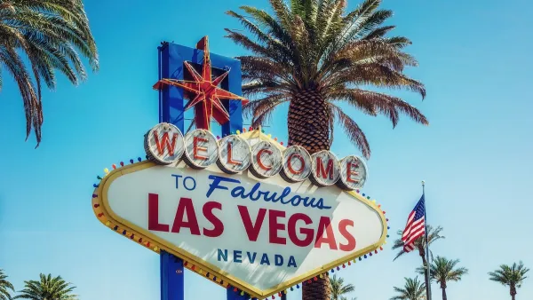 "Welcome to fabulous Las Vegas Nevada" sign with mottled shade from palm tree.