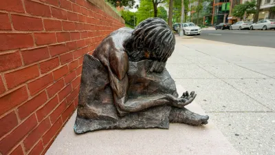 Bronze statue of homeless man (Jesus) with head down and arm outstretched in front of St. Matthew Cathedral in Washington D.C.