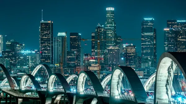 Nighttime view of downtown Los Angeles through arches of new 6th Street Viaduct.