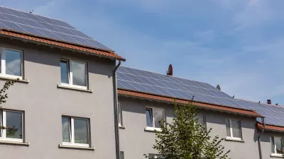 Solar panels on roof of grey residential building