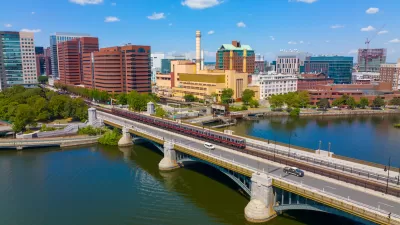 Cambridge Kendall Square skyline and MBTA red line train on Longfellow Bridge aerial view, Boston, Massachusetts MA, USA.