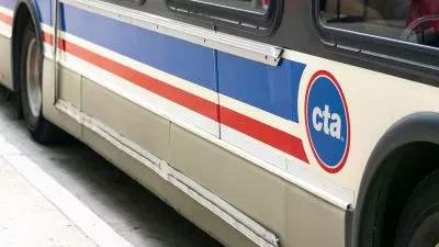 Close-up of side of white and blue and red Chicago Transit Authority bus.