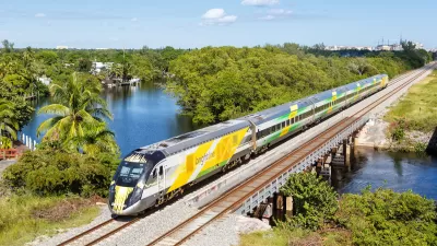 Aerial view of yellow Brightline high-speed rail train in Deerfield Beach, Florida.