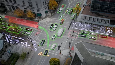 Aerial view of vehicles on city street with superimposed graphic arrows indicating autonomous cars.