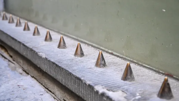 Spikes on building designed to prevent people from sitting.