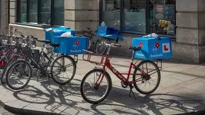 Domino's Pizza delivery bikes parked on a sidewalk in London, UK.