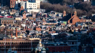 Aerial view of dense South Side Flats neighborhood in Pittsburgh, PA with Orthodox church spires in foreground.