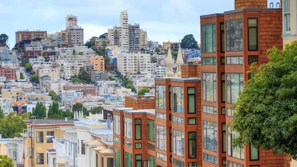 Dense multistory residential buildings in hilly San Francisco, California.