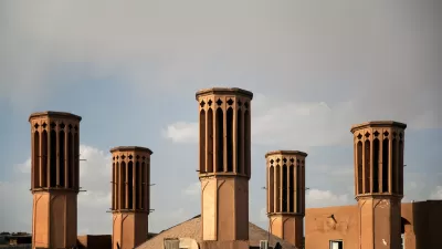 Elevated view of five windcatcher ventilation towers on rooftops in Yazd, Iran.