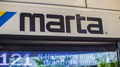 Close-up of MARTA logo on side of white city bus in Atlanta, Georgia.