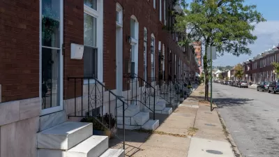 Row of red brick rowhouses with white marble steps in Baltimore, Maryland.