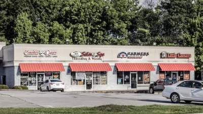 One-story strip mall with red awnings.