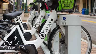 B-cycle bike share station with white bikes on street in San Antonio, Texas.